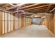 Unfinished basement featuring concrete flooring, exposed ceiling, and wooden framing with natural light at 3267 Remembrance Trce, Lawrenceville, GA 30044