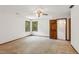 Bright bedroom features two windows letting in natural light, neutral carpet, and ceiling fan at 3267 Remembrance Trce, Lawrenceville, GA 30044