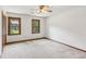 Bedroom with a ceiling fan and two windows providing ample natural light at 3267 Remembrance Trce, Lawrenceville, GA 30044