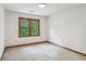 Bright bedroom with a large window overlooking a treed yard at 3267 Remembrance Trce, Lawrenceville, GA 30044