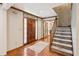 Warm and inviting foyer with hardwood floors, a wooden staircase, and natural light at 3267 Remembrance Trce, Lawrenceville, GA 30044