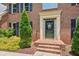 Inviting front entrance with a decorative door, trimmed with manicured landscaping and brick steps at 3267 Remembrance Trce, Lawrenceville, GA 30044