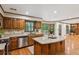 Spacious kitchen featuring an island, granite countertops, and wood cabinetry at 3267 Remembrance Trce, Lawrenceville, GA 30044