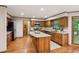 Well-lit kitchen with wood cabinets, granite countertops, and an island at 3267 Remembrance Trce, Lawrenceville, GA 30044