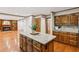Kitchen with granite countertops, wooden island, and view into living room at 3267 Remembrance Trce, Lawrenceville, GA 30044
