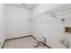 Empty laundry room with tile floor, with dryer connections and a wire rack for storage at 3267 Remembrance Trce, Lawrenceville, GA 30044