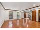 Spacious living room with wood floors, wainscoting, and dark wood trim at 3267 Remembrance Trce, Lawrenceville, GA 30044