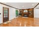 Bright living room featuring hardwood floors, fireplace, and built-in bookshelves at 3267 Remembrance Trce, Lawrenceville, GA 30044