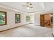Spacious bedroom with tray ceiling and two windows, offering a serene and airy atmosphere at 3267 Remembrance Trce, Lawrenceville, GA 30044