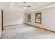 Large bedroom with a tray ceiling and ample natural light from the two windows at 3267 Remembrance Trce, Lawrenceville, GA 30044