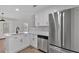 Contemporary kitchen featuring stainless steel appliances, white cabinets, and a breakfast bar for added convenience at 3417 Sable Chase Ln, Atlanta, GA 30349