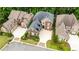 An aerial view of a brick home featuring a dark gray roof, large driveway, and manicured landscaping at 1250 Atherton Park, Roswell, GA 30076