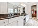 Bright bathroom featuring granite countertops, white cabinets, and a view into a well-organized walk-in closet at 1250 Atherton Park, Roswell, GA 30076