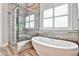 Luxurious bathroom showcasing a freestanding tub and glass-enclosed shower with beautiful tile work at 1250 Atherton Park, Roswell, GA 30076