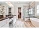 Luxurious bathroom featuring a soaking tub, glass-enclosed shower, and dual vanities at 1250 Atherton Park, Roswell, GA 30076