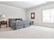 Large bedroom with neutral colors, plush carpet, and plenty of natural light from the window at 1250 Atherton Park, Roswell, GA 30076