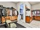Spacious walk-in closet with custom shelving, clothing racks, and built-in storage, next to a laundry room at 1250 Atherton Park, Roswell, GA 30076