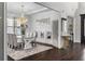 Open dining room with a modern chandelier, a glass table, and decorative wall art at 1250 Atherton Park, Roswell, GA 30076