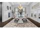 Dining room with a glass table, upholstered chairs, chandelier and decorative rug at 1250 Atherton Park, Roswell, GA 30076