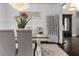 Formal dining room with elegant chandelier, wainscoting, and a glass-top table at 1250 Atherton Park, Roswell, GA 30076