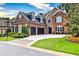 Beautiful brick and stone home with a two-car garage, manicured landscaping, and a well-maintained lawn at 1250 Atherton Park, Roswell, GA 30076