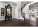 Elegant foyer with dark hardwood floors, staircase, and a decorative display cabinet, creating a welcoming entrance at 1250 Atherton Park, Roswell, GA 30076