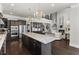 Open-concept kitchen with granite countertops, island seating, and modern lighting fixtures at 1250 Atherton Park, Roswell, GA 30076