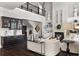 Elegant living room showcasing a fireplace, built-in shelving, dark wood floors and stairs to the second floor at 1250 Atherton Park, Roswell, GA 30076