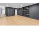 Finished basement boasts wood-look flooring, recessed lighting, and built-in shelving at 12995 Bucksport Dr, Roswell, GA 30075