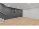 Spacious finished basement with recessed lighting, wood-look floors, and one small window at 12995 Bucksport Dr, Roswell, GA 30075