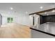Open finished basement with recessed lighting, wood-look floors, and a wet bar at 12995 Bucksport Dr, Roswell, GA 30075