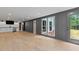 Finished basement with wood-look flooring, recessed lights, a bar, and outdoor access at 12995 Bucksport Dr, Roswell, GA 30075