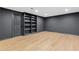Spacious basement with recessed lighting, wood-look flooring, and a built-in bookshelf at 12995 Bucksport Dr, Roswell, GA 30075