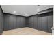 Finished basement with recessed lighting, wood-look floors, and stylish wall paneling at 12995 Bucksport Dr, Roswell, GA 30075