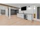 Finished basement features a wet bar, shiplap accent wall, and wood-look flooring at 12995 Bucksport Dr, Roswell, GA 30075