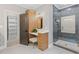Well-appointed bathroom with vanity, linen closet, and glass-enclosed shower at 12995 Bucksport Dr, Roswell, GA 30075