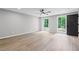 This is a view of the bedroom with hardwood floors and ample natural light at 12995 Bucksport Dr, Roswell, GA 30075