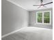 Bedroom features large window, neutral paint and ceiling fan at 12995 Bucksport Dr, Roswell, GA 30075