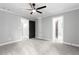Large bedroom with ceiling fan, neutral walls, and access to the ensuite bath at 12995 Bucksport Dr, Roswell, GA 30075