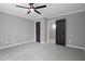 Bedroom features two doorways, grey paint, and ceiling fan at 12995 Bucksport Dr, Roswell, GA 30075