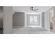 Well lit bonus room features a grey color scheme and large window at 12995 Bucksport Dr, Roswell, GA 30075