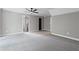 Large bonus room features two doorways, carpet, and ceiling fan at 12995 Bucksport Dr, Roswell, GA 30075
