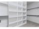 Spacious walk-in closet with custom shelving and ample storage space at 12995 Bucksport Dr, Roswell, GA 30075