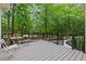 This home features a charming outdoor deck area surrounded by lush greenery at 12995 Bucksport Dr, Roswell, GA 30075
