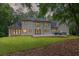 Exterior rear of the house, highlighting windows and a well maintained yard at 12995 Bucksport Dr, Roswell, GA 30075