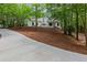 Landscaped front yard features a sprawling lawn and a private driveway to the house at 12995 Bucksport Dr, Roswell, GA 30075