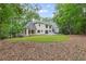 The exterior of this home is nestled among mature trees with lush landscaping at 12995 Bucksport Dr, Roswell, GA 30075