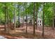 Charming home nestled among mature trees on a well-manicured, sloped lot at 12995 Bucksport Dr, Roswell, GA 30075