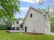 A beautiful home's exterior featuring a pristine white stucco finish, a spacious deck, and a lush green lawn at 12995 Bucksport Dr, Roswell, GA 30075