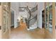 Grand foyer with a curved staircase, hardwood floors, and abundant natural light at 12995 Bucksport Dr, Roswell, GA 30075